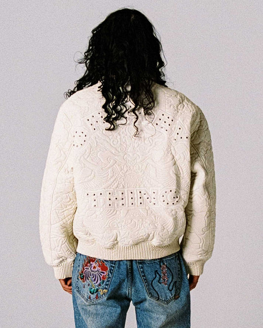 Chaqueta de cuero sintético blanca off white de la marca Grimey, estilo casual con detalles modernos y cierre frontal.