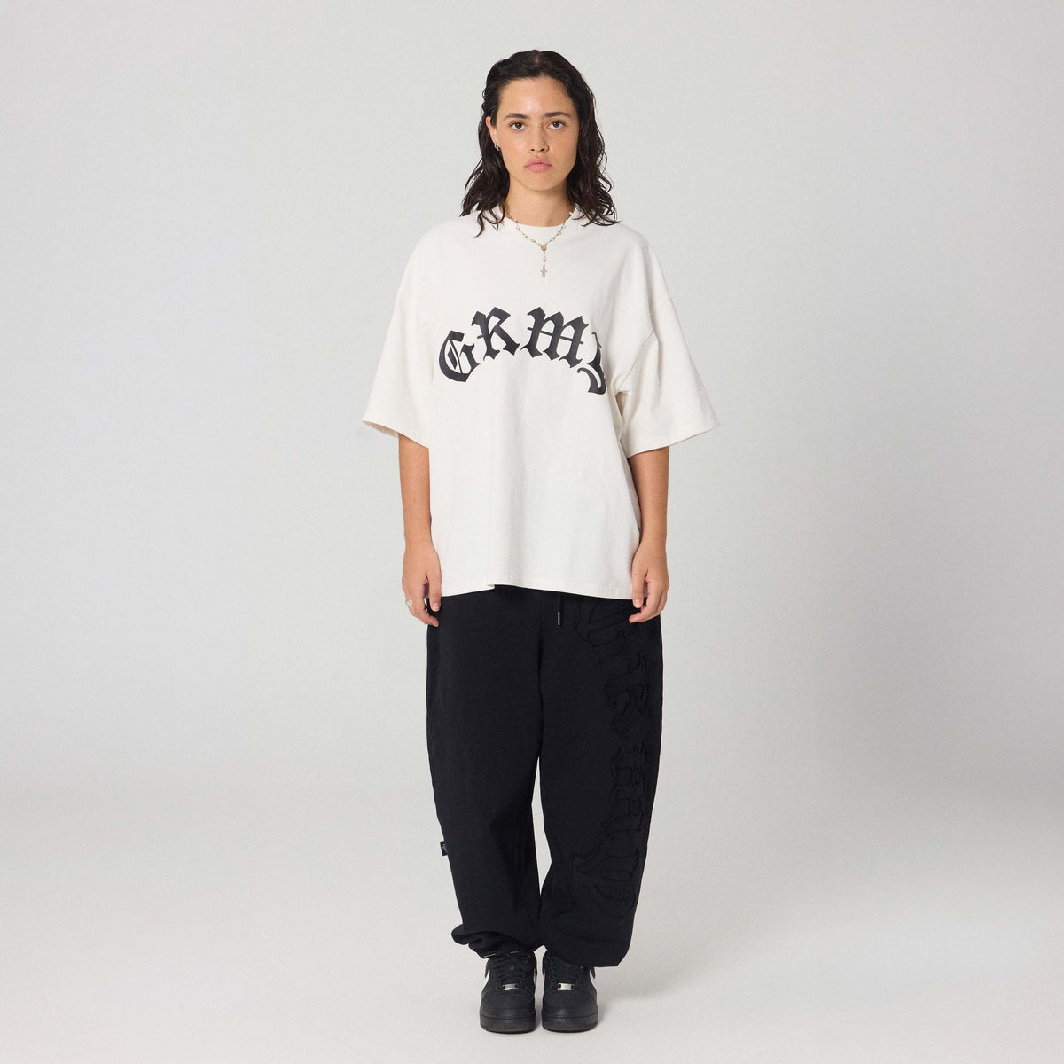 Camiseta boxy blanca con mensaje "Rise Above" de la marca Grimey, vista frontal en estilo casual y moderno.