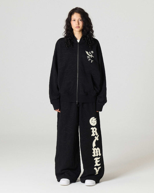 Pantalón Grimey Odd Cutlass Snap en negro, pantalones deportivos con diseño moderno y detalles en la cintura.