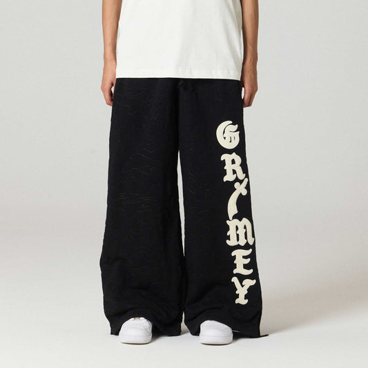 Pantalón negro Grimey Odd Cutlass Snap, estilo casual con detalles de botones y corte ajustado, visible en la imagen.