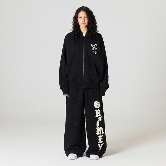 Sudadera gris oscuro con cierre y capucha de la marca Grimey, estilo Odd Cutlass, vista frontal con detalles en la imagen.