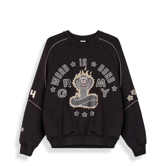 Sudadera Sho Nuff negra de la marca Grimey, con diseño de manga larga y logo en el pecho, en color negro sobre fondo blanco.
