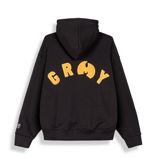 Sudadera Tical X Grimey en negro con detalles en amarillo, de corte regular y estilo urbano, vista frontal.